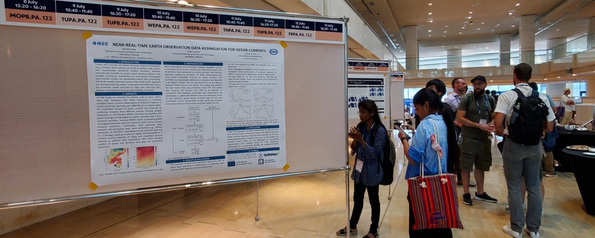 Poster on display in a hallway. A young woman wearing a totebag looking at the poster.